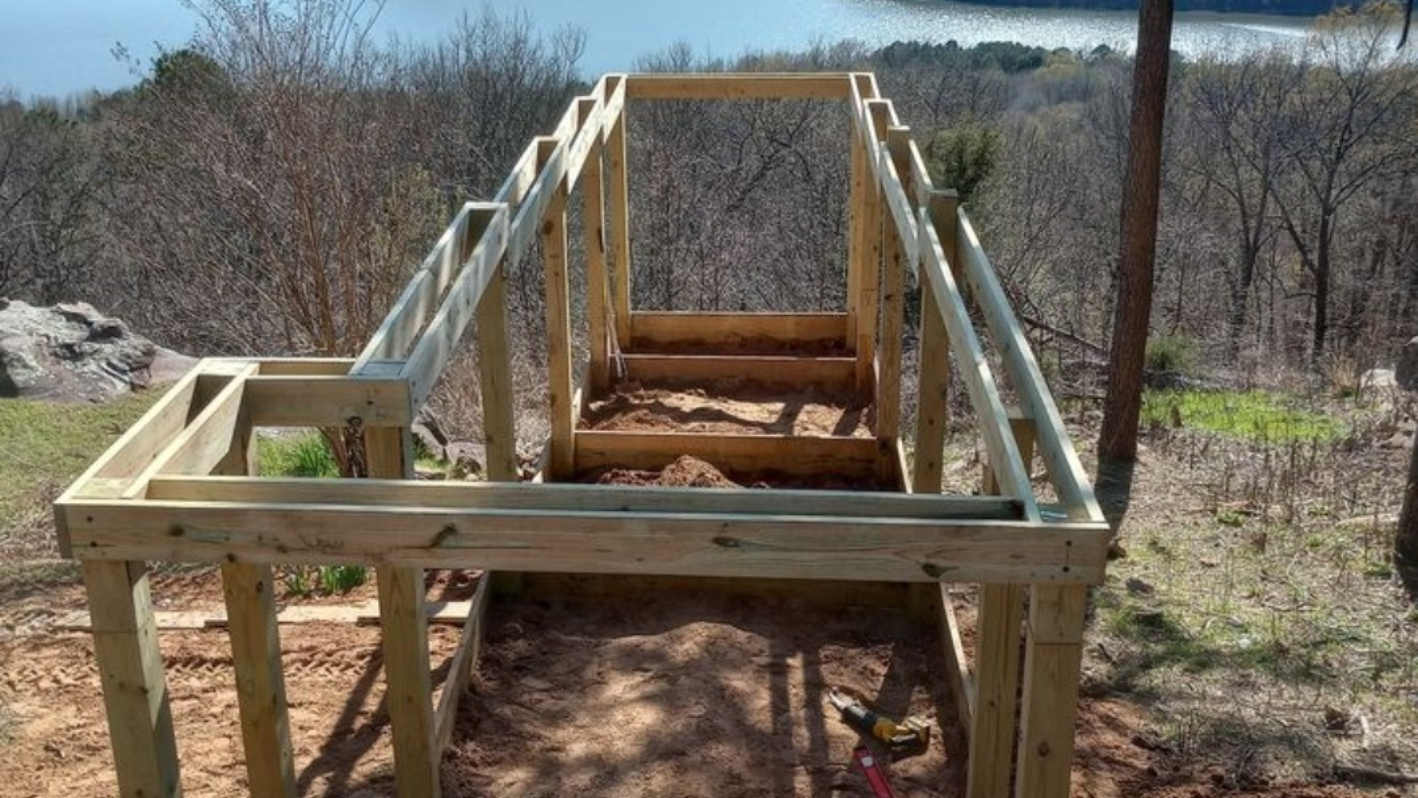 Wooden bridge or walkway under construction in a wooded area