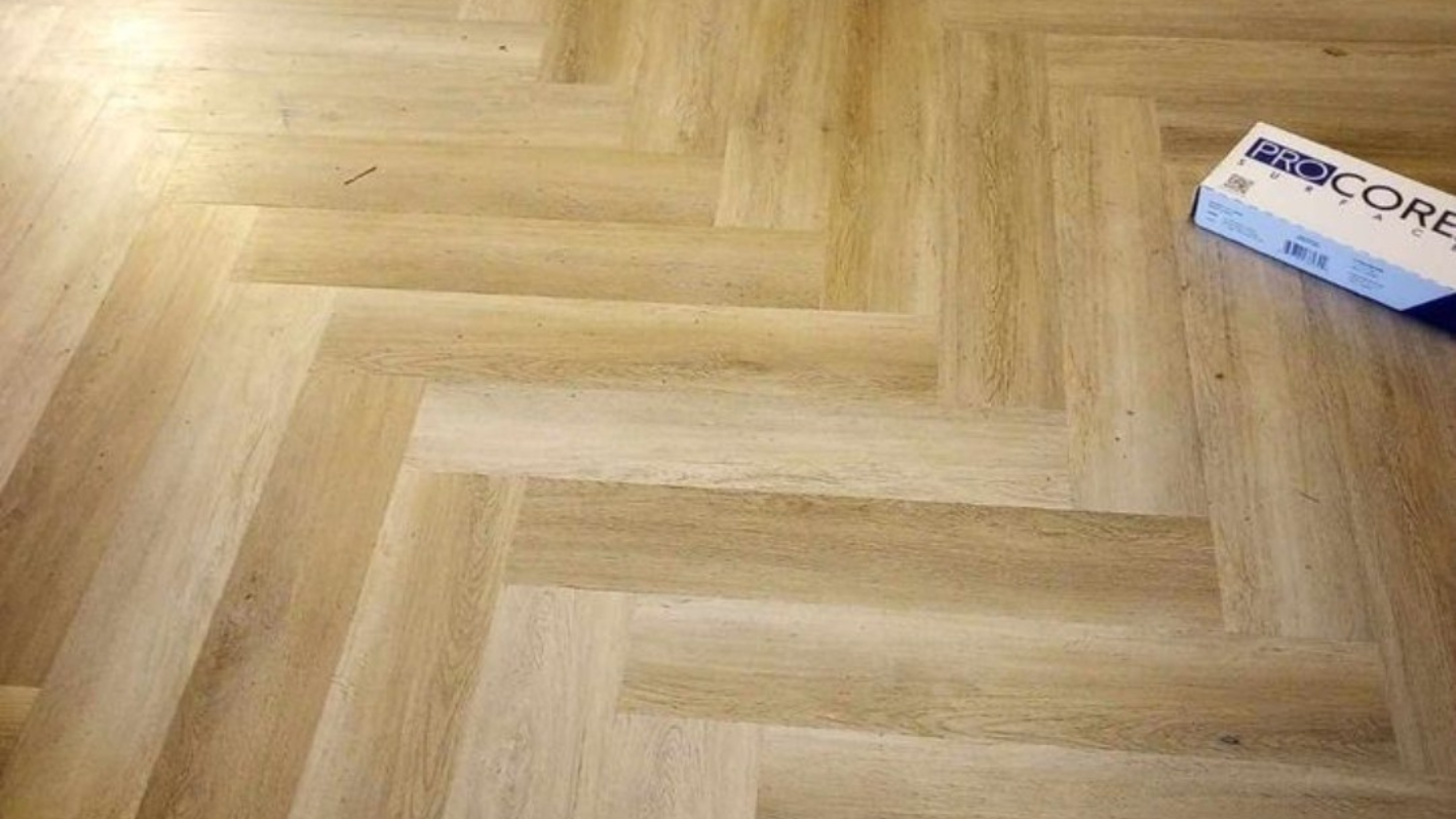 Herringbone wooden floor with Procore flooring box in corner